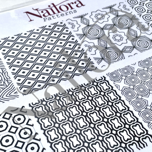 A close-up of Nailora Patterns nail nail art sheets showing various black and white geometric and floral designs.