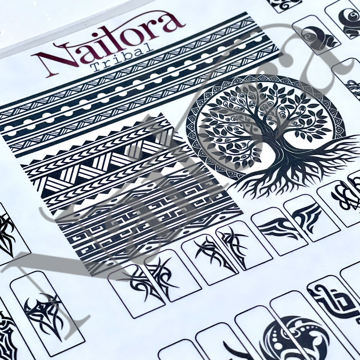 A close-up of a Nailora Tribal traceable nail art sheet featuring black tribal patterns, geometric bands, a tree of life motif, and small symbol blocks on a white background.